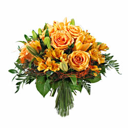 Bouquet rond aux tons oranges avec des fleurs de saison et verdure